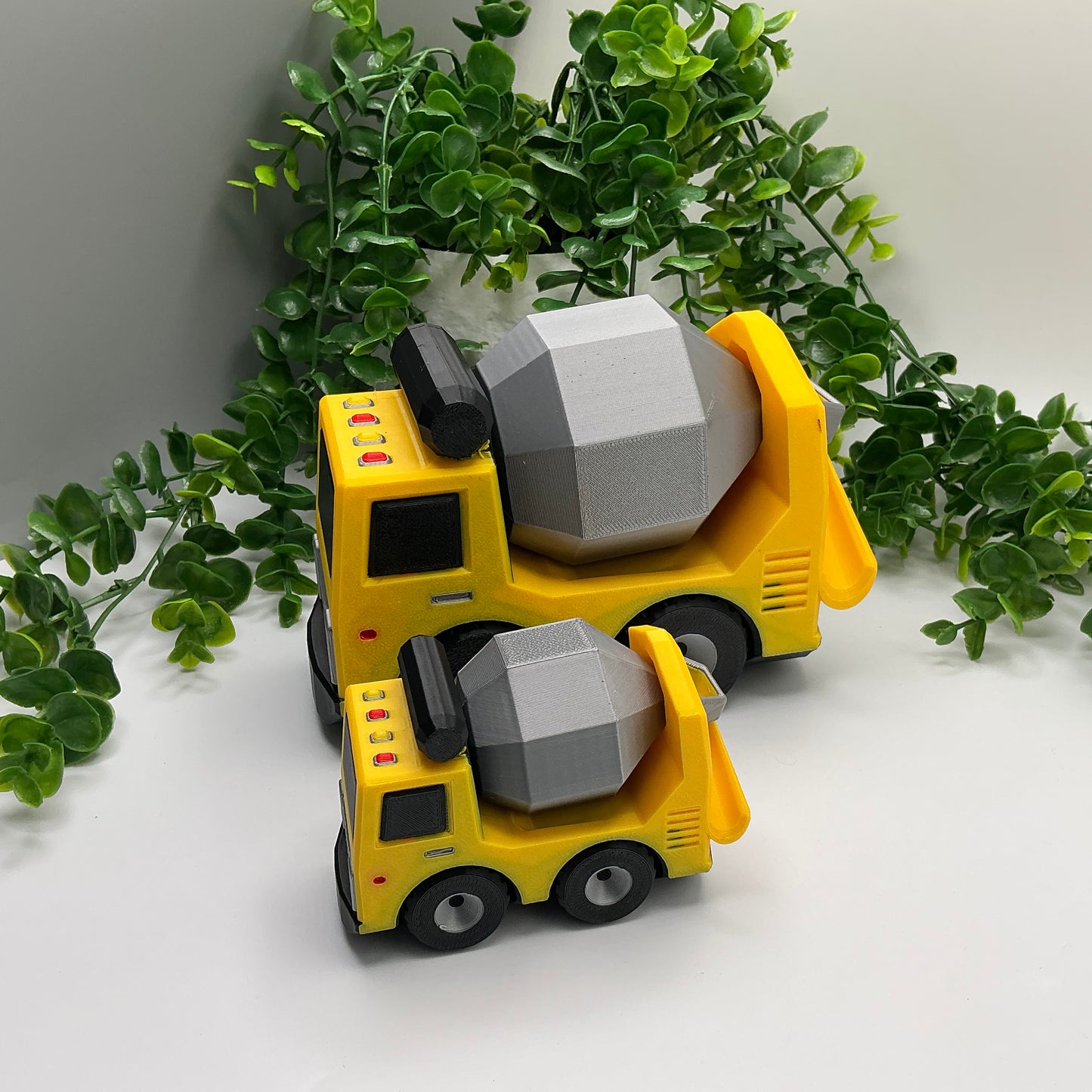 Large 3D-printed multi-coloured cement truck construction vehicle with rotating mixer drum - view 5 of 5