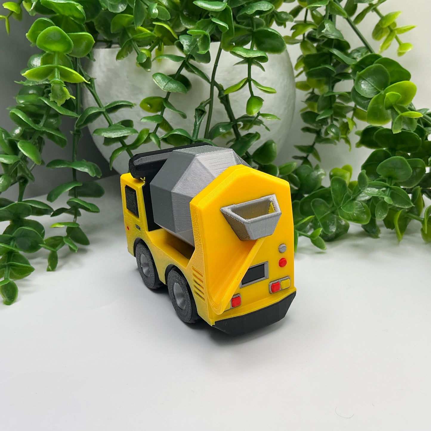 3D-printed multi-coloured cement truck construction vehicle with rotating mixer drum - view 2 of 3