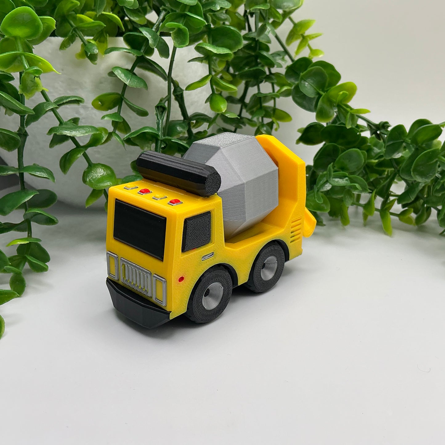 3D-printed multi-coloured cement truck construction vehicle with rotating mixer drum - view 1 of 3