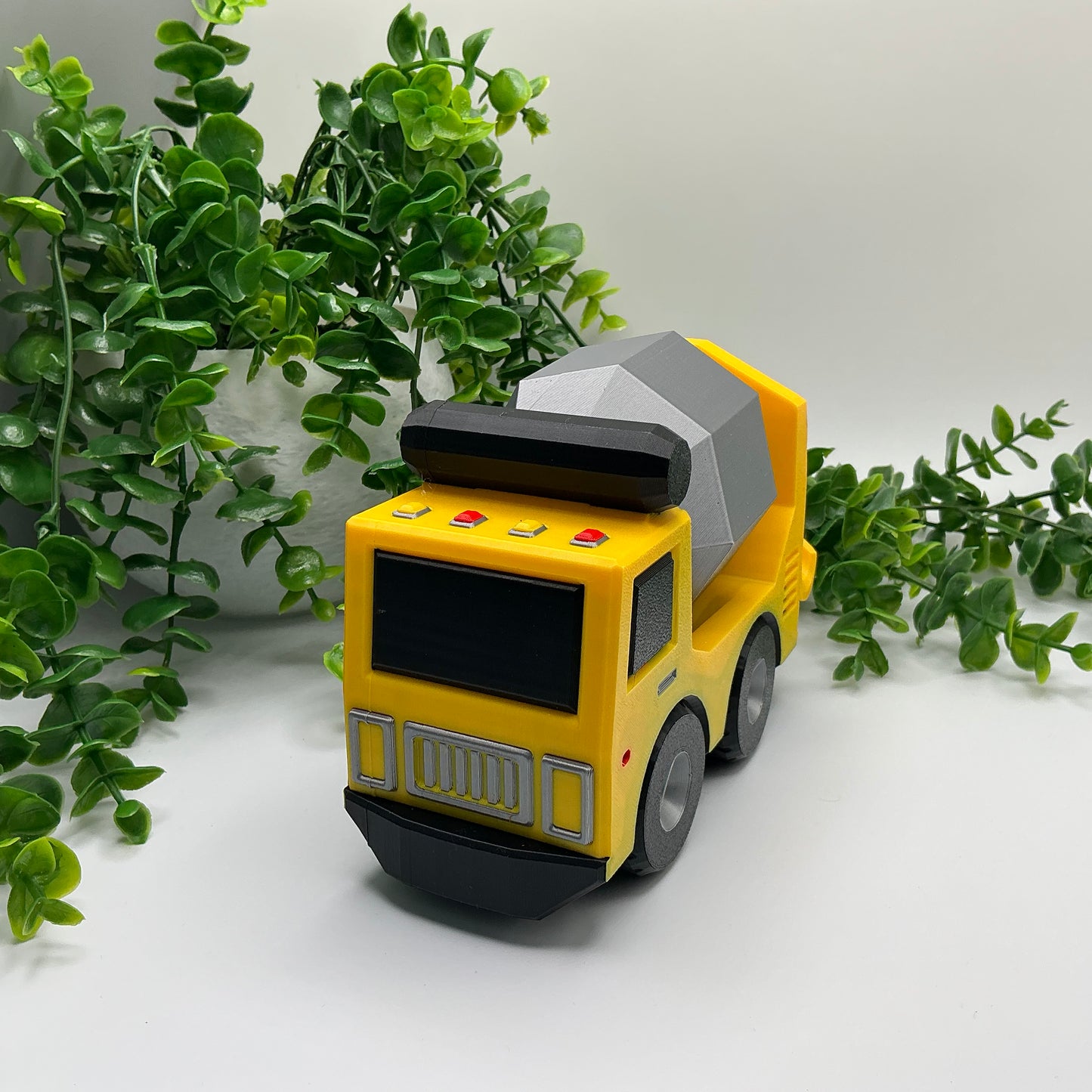 Large 3D-printed multi-coloured cement truck construction vehicle with rotating mixer drum - view 1 of 5