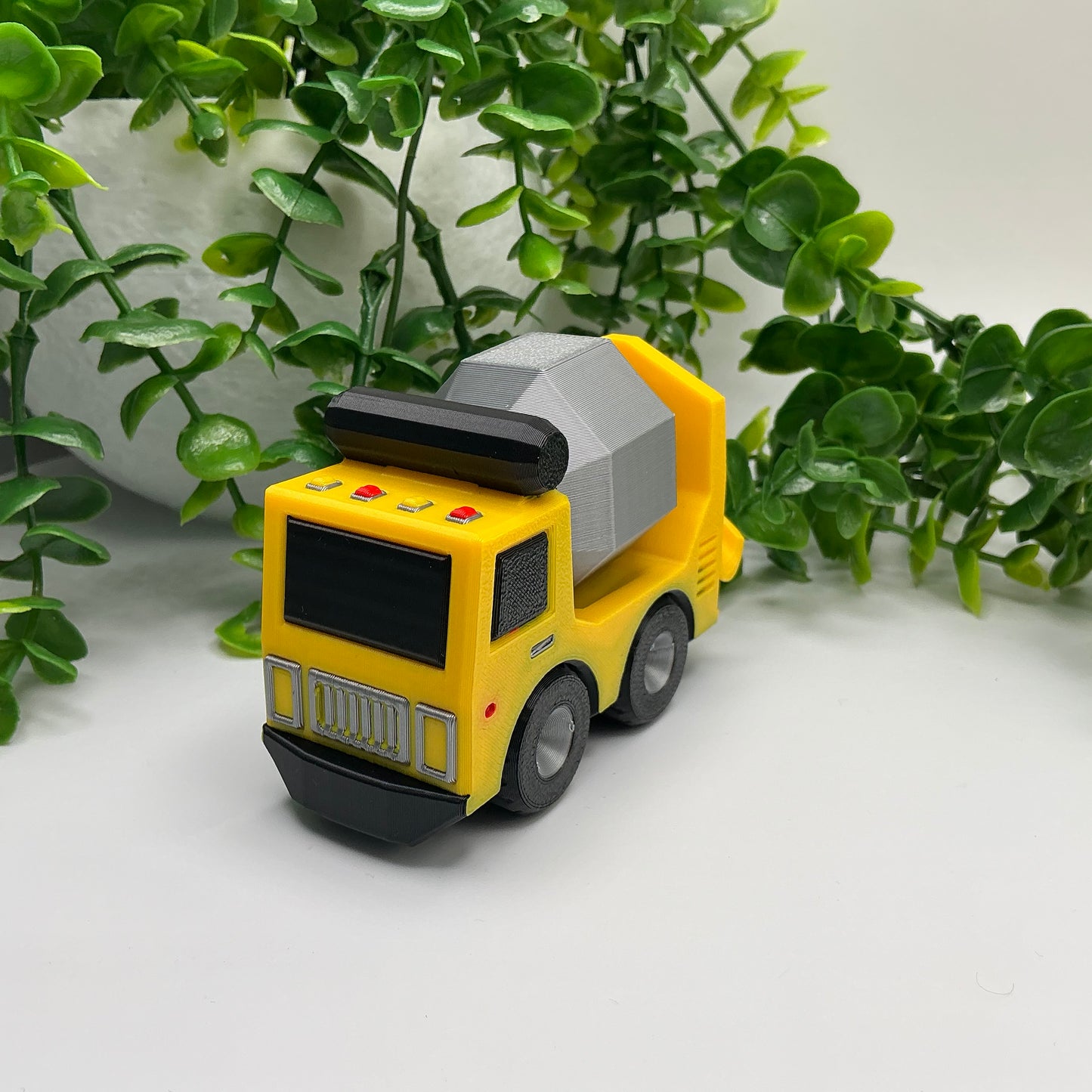 3D-printed multi-coloured cement truck construction vehicle with rotating mixer drum - view 3 of 3